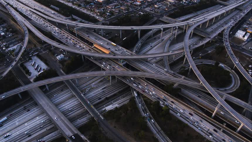 Aerial view of heavy traffic on the overpass in a highway intersection in the city