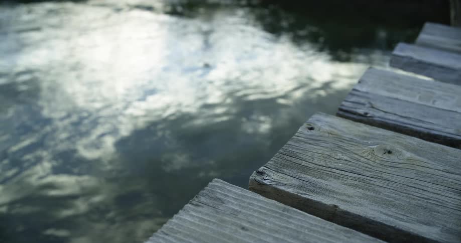 Wood planks on a dock are above a water
