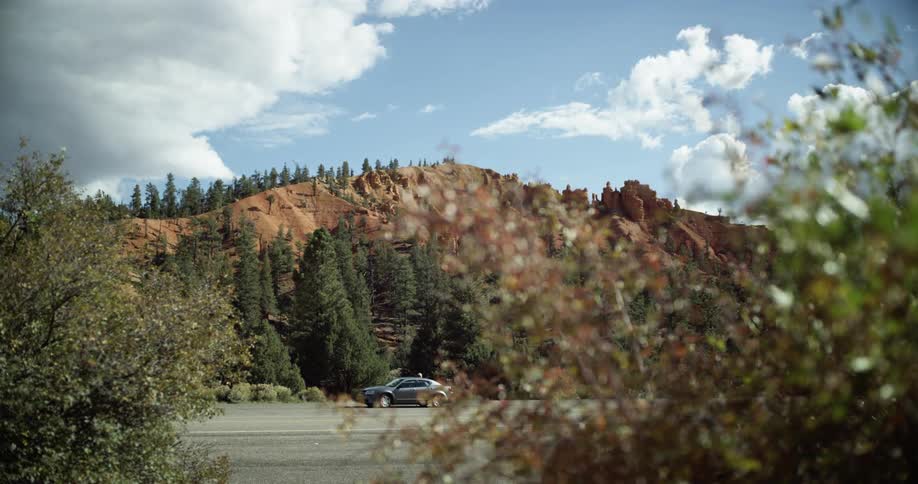 A panning shot revealing a car