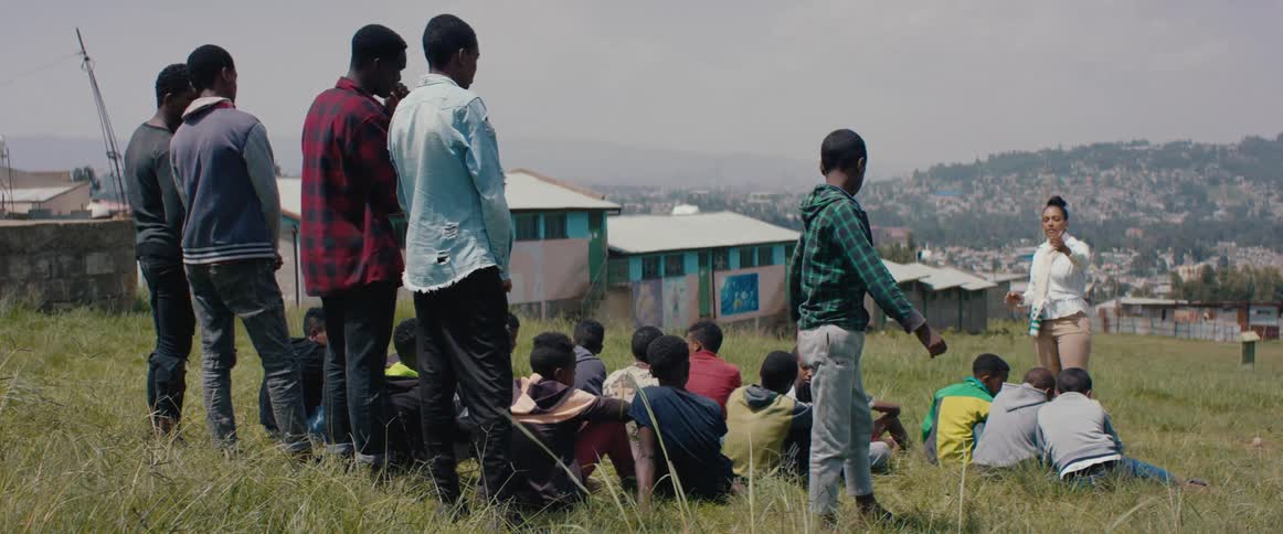 A woman singling out a child trying to leave from a group