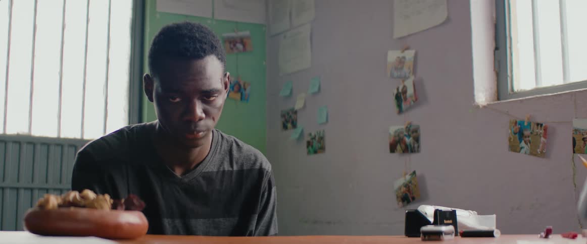 A teenager shaking while sitting