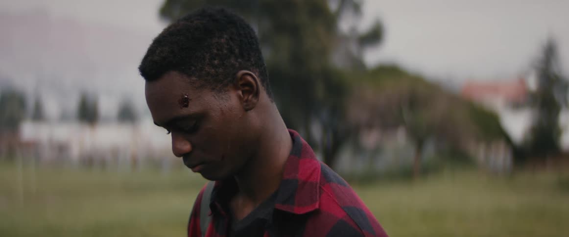 A man is looking down at the field