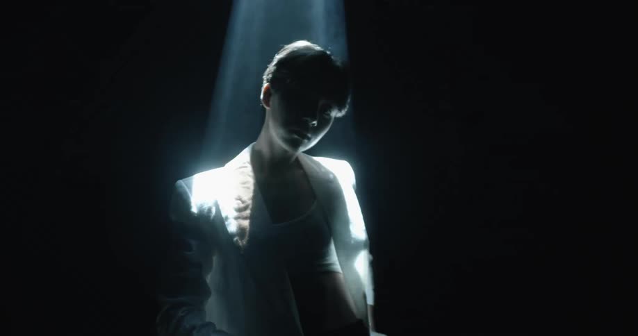 A man standing under a spotlight