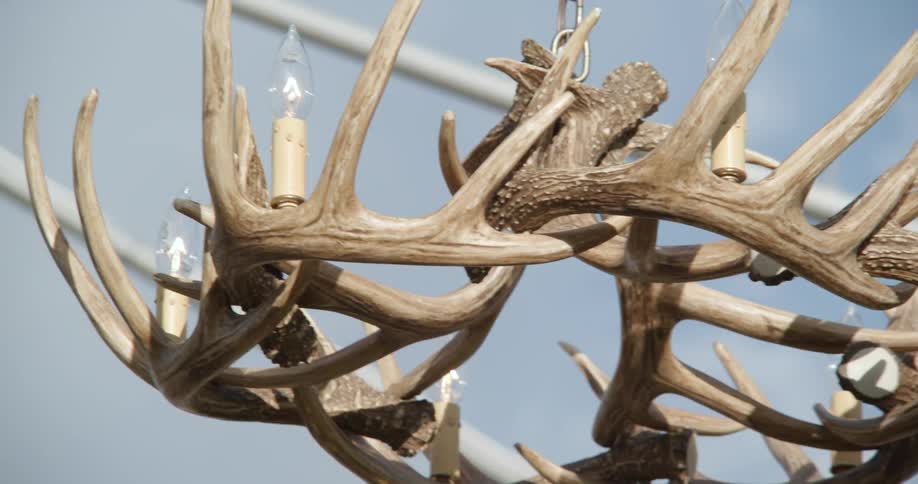 An antler chandelier swings in the wind