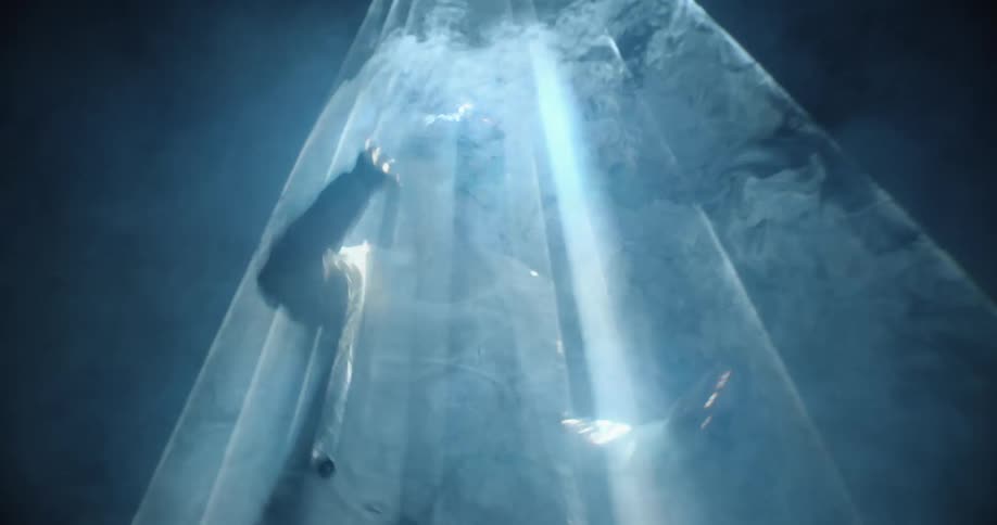 A man standing under a strobing light