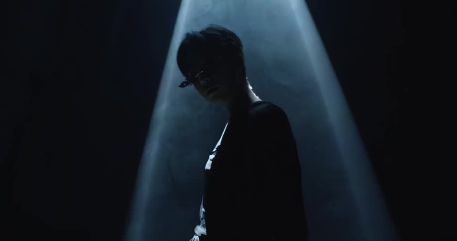 Human posing in spotlight