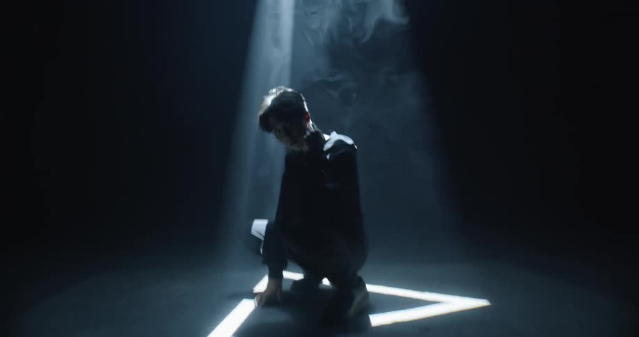 A man standing under a spotlight