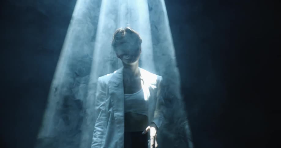 A model poses under a spotlight