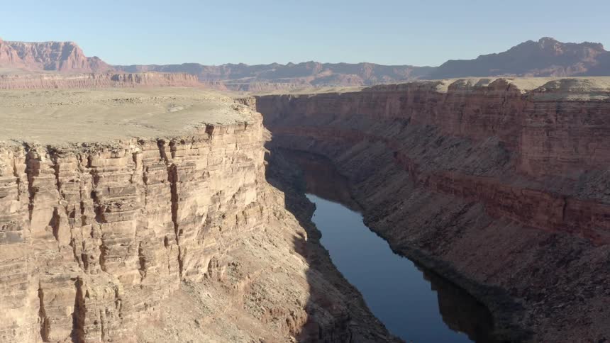 River deep inside river canyon and mountain range on the horizon on a clear day