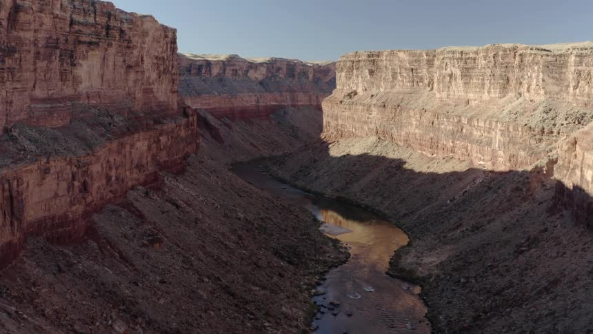 Aerial view of a river flowing through a valley of a canyon