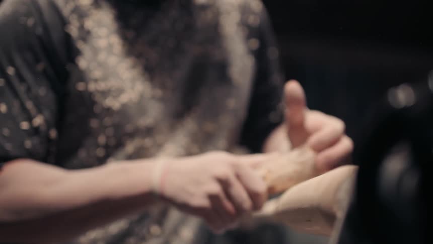 A man sanding a baseball bat