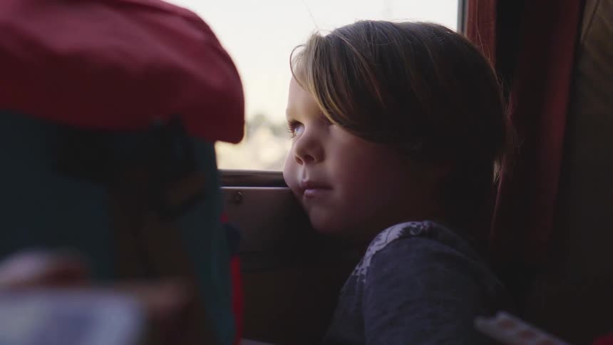 Child staring out window