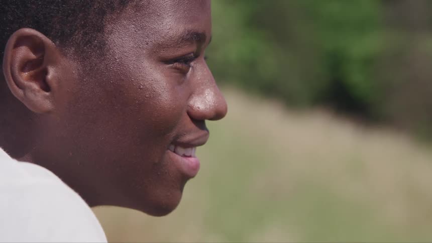 A man is outdoors and is smiling