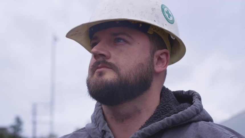 A man with a construction hat standing