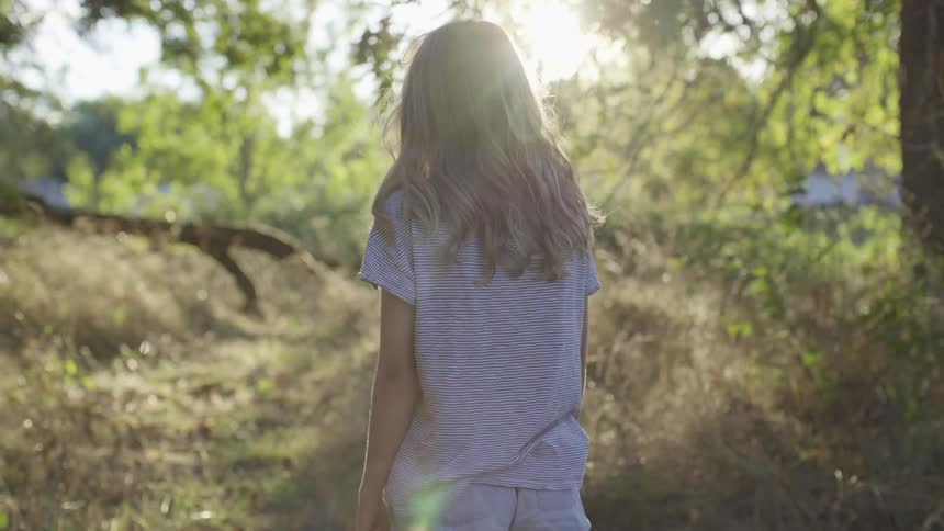 A woman walking down a trail path