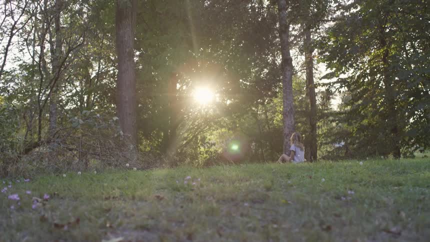 Child sitting in forest