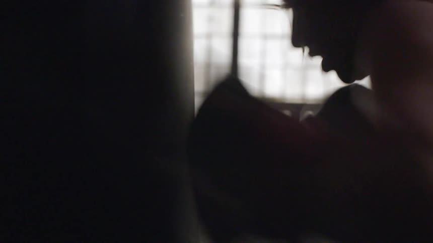 A woman punches a punching bag