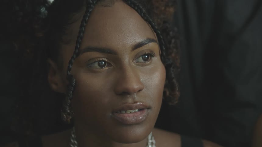 A woman is looking forward and nodding