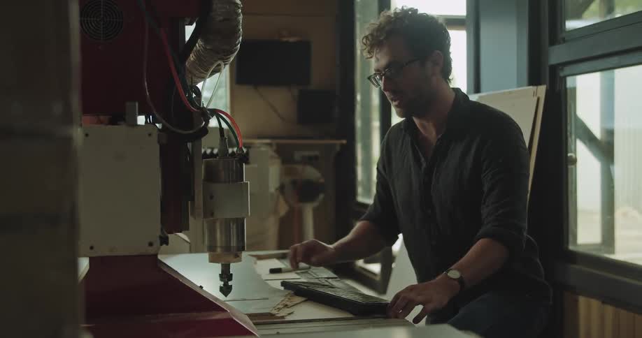A man starting a cnc machine