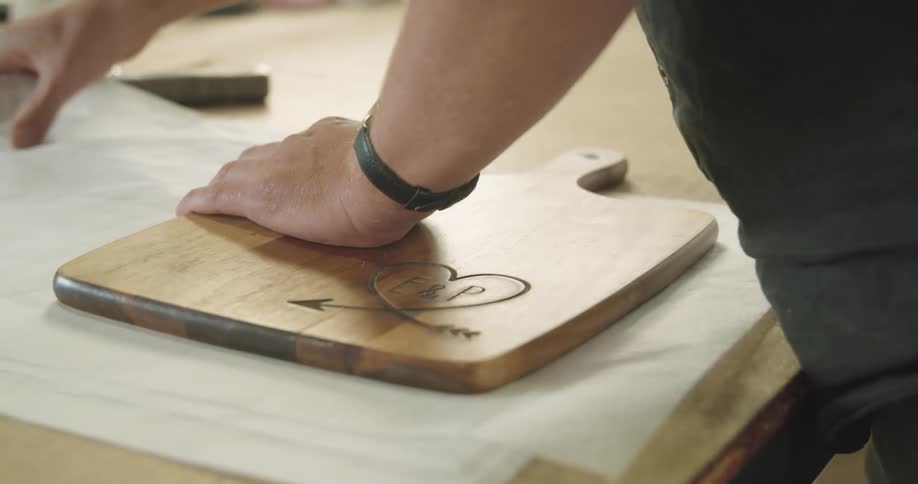A man wraps up a cutting board in a store