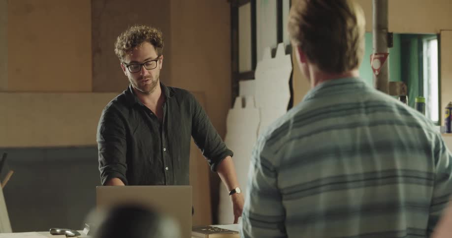 Two males talking to each other in a workshop