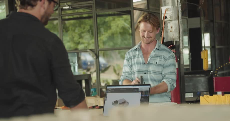 Two men working together in a workshop