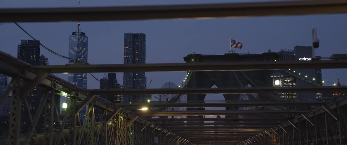 The flag blows in the wind on the bridge
