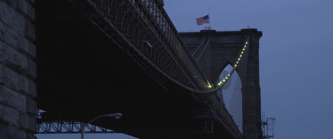 A flag is waving on top of a bridge