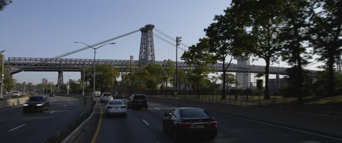 Vehicles driving near the williamsburg bridge suspension bridge in new york city