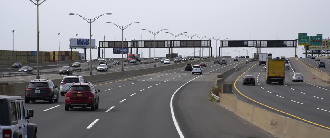 Cars and trucks travel on the multi lane highway