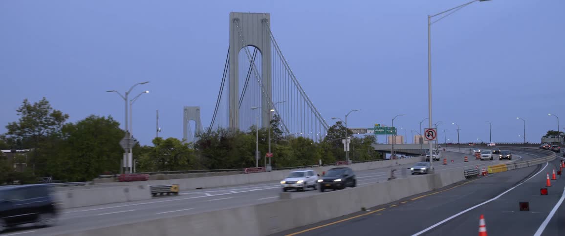 Cars driving on highway as bridge is revealed
