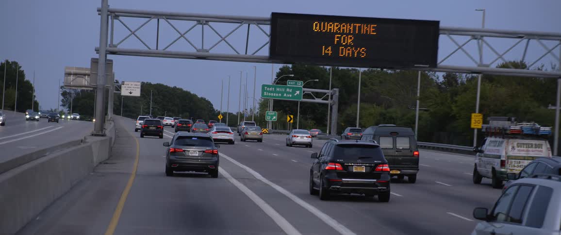 Heavy traffic travels along a highway near exits