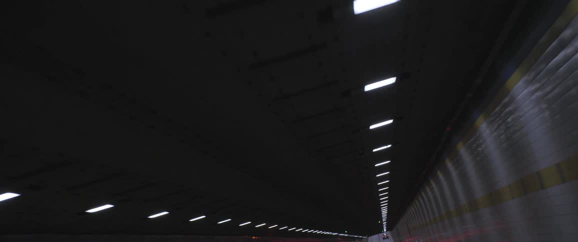 A tunnel with lights and a vehicle