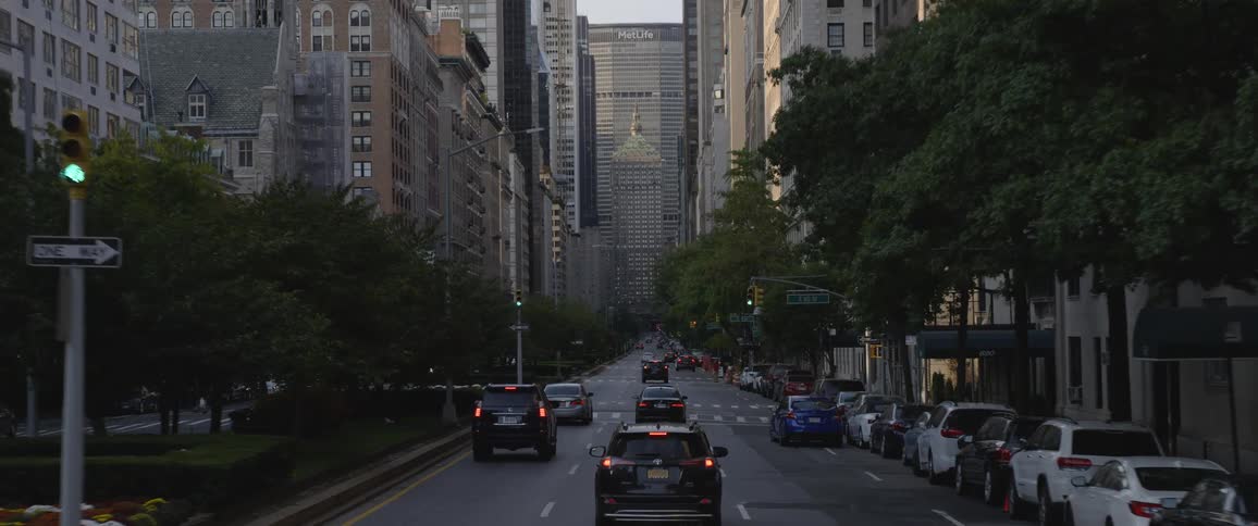 Cars driving down a city street