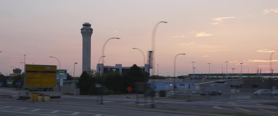 Traffic control tower in an airport at sunset