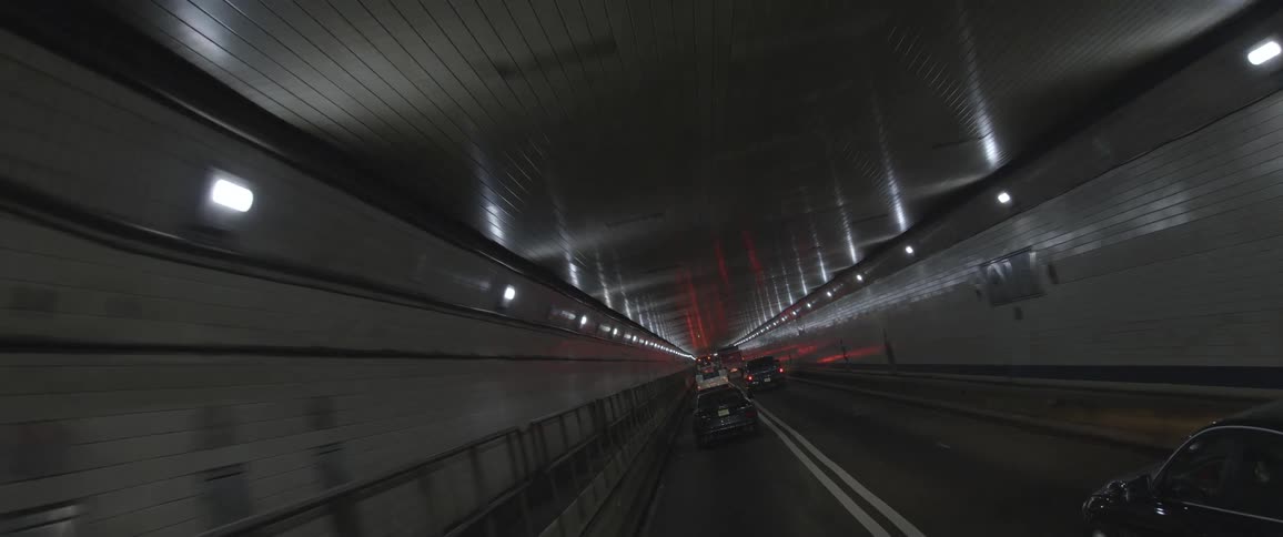 Driving on a road in a tunnel with traffic