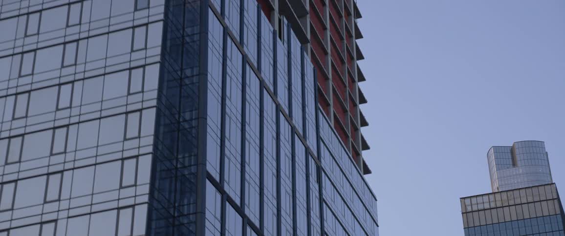 A tall tower in the middle of construction in a metro area