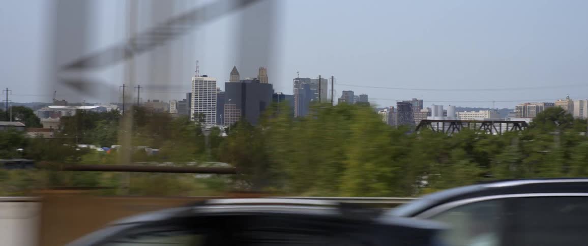 City skyline seen from moving car on highway