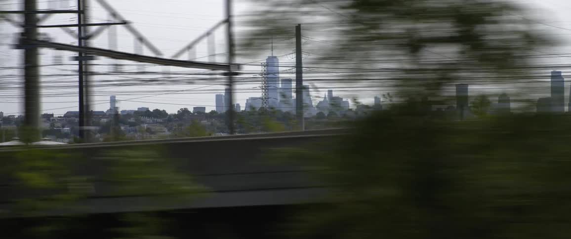 New york city skyline in the horizon behind power lines and bridges