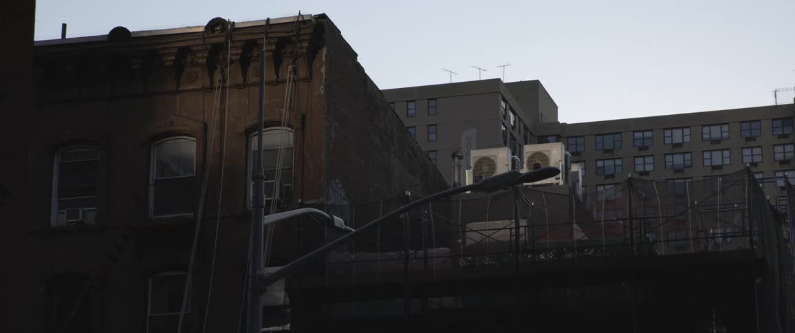 Dark facade of apartment buildings in a city at evening
