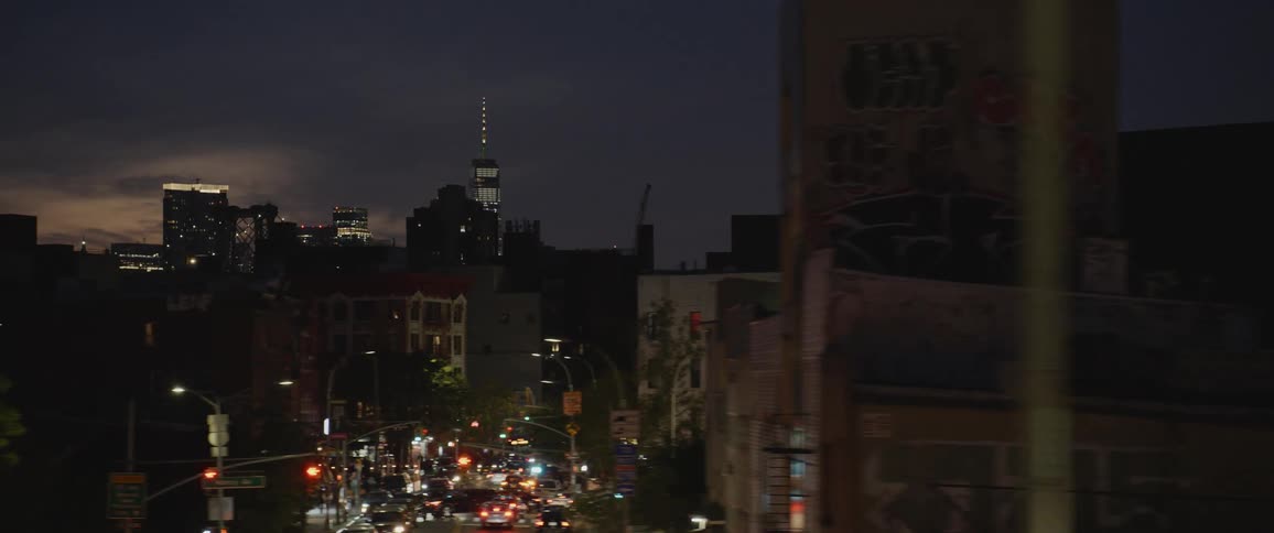 New york city downtown skyscraper skyline at night filmed from a moving vehicle