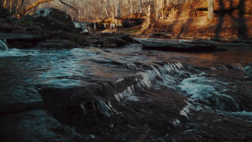 Water is flowing outdoors at dusk