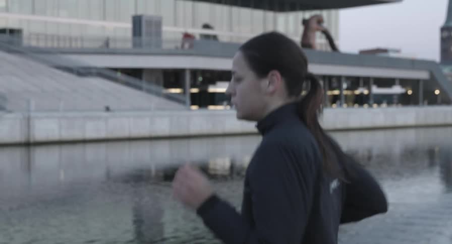 A woman jogs on a cold overcast day