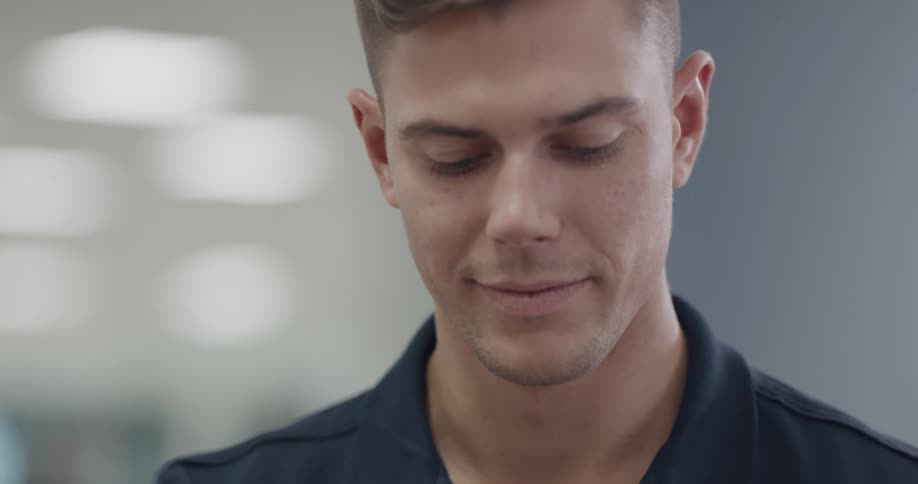 Close up of a young handsome man smiling in a room