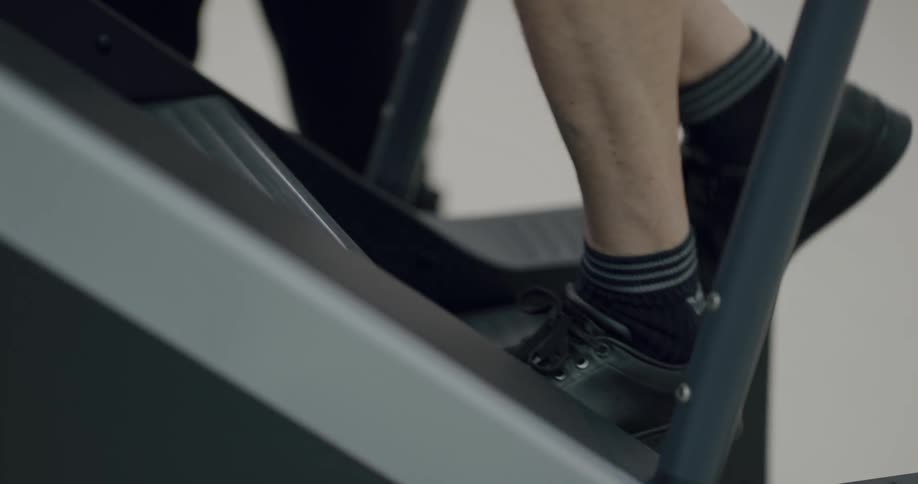 Man exercising on a stair climber stepper indoors