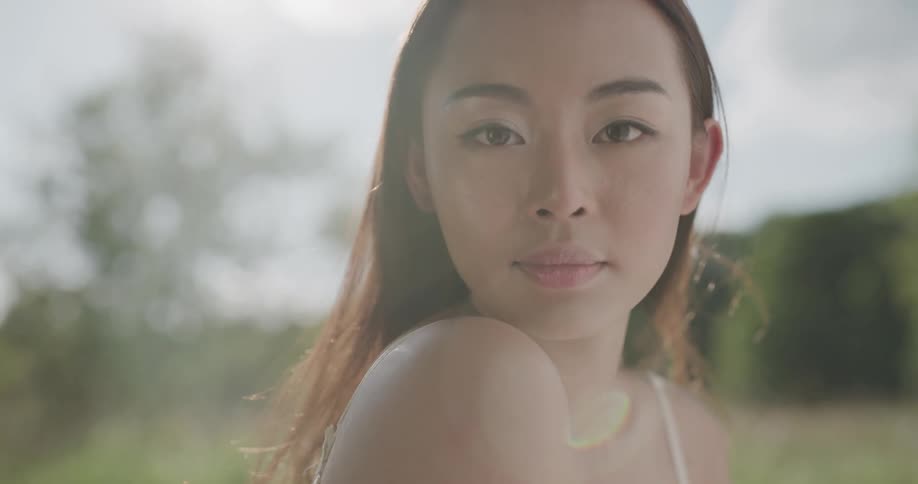 A woman in a field poses for a picture