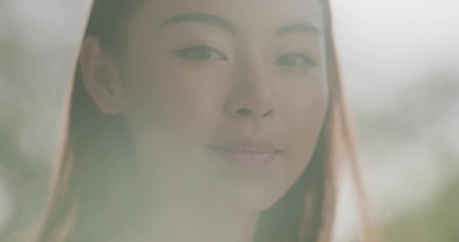 Close up of a young womans face outdoors at sunset