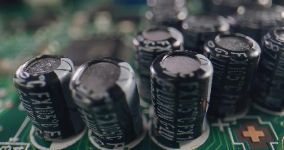 Extreme close up of the electronic components of a green circuit board