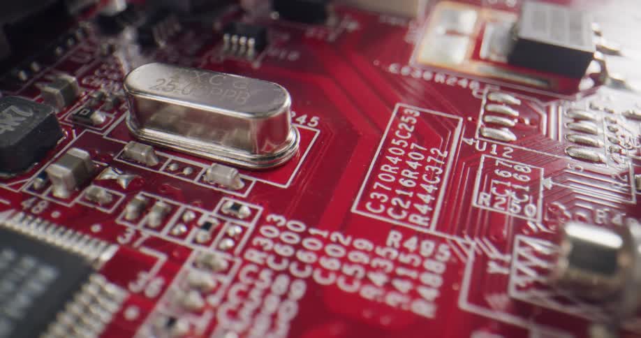 Extreme close up of the components of a red computer circuit board