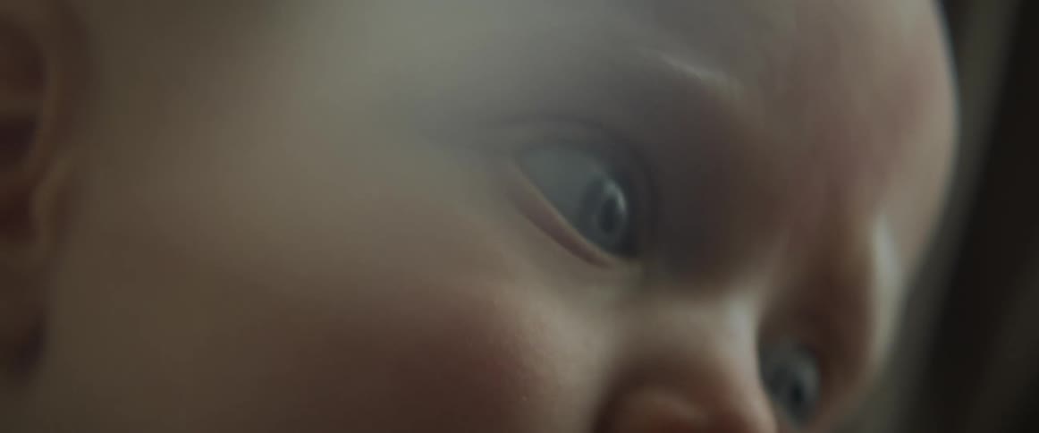 Close up of a babys face staring at the camera